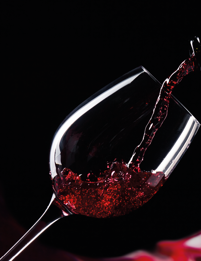 bottle and glass with red wine on a black background