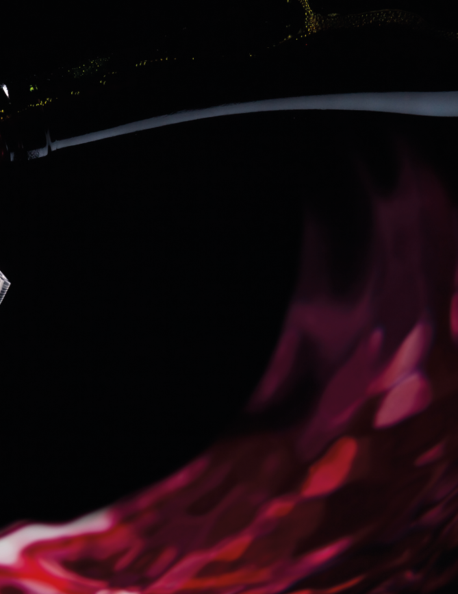bottle and glass with red wine on a black background
