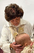 A woman holding a baby. Description generated by AI