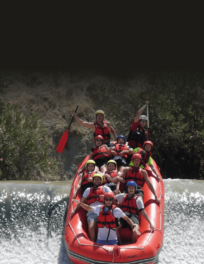 A group of people are on a raft in a river. Description generated by AI