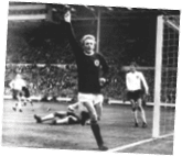A soccer player in a black and white photo is about to kick the ball. Description generated by AI