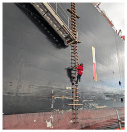 A man is climbing a ladder on a boat. Description generated by AI