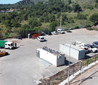 A parking lot with several cars and trucks parked. Description generated by AI