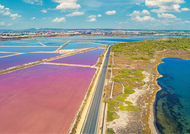 A large body of water with a road running through it. Description generated by AI