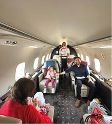 A group of people are sitting in a plane. Description generated by AI