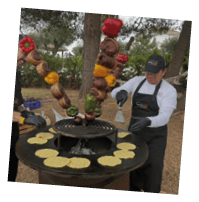 A man is cooking food on a grill. Description generated by AI