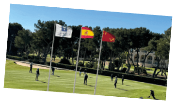 A group of people playing golf on a green course. Description generated by AI