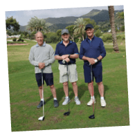 Four men standing on a golf course. Description generated by AI