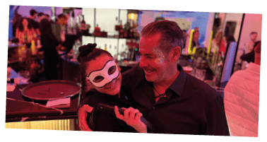 A man and woman are standing in a bar. Description generated by AI