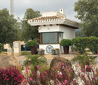 A white building with a brown roof. Description generated by AI