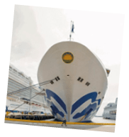 Two large cruise ships docked at a pier. Description generated by AI
