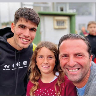 A man and a girl are smiling and posing for a picture. Description generated by AI