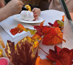 A table with a plate of food and a pumpkin on it. Description generated by AI
