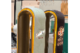 Two beer taps with a green and a brown label. Description generated by AI