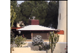 A house with a red roof and a white chimney. Description generated by AI
