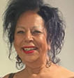 A woman with black hair and a red lipstick smile. Description generated by AI