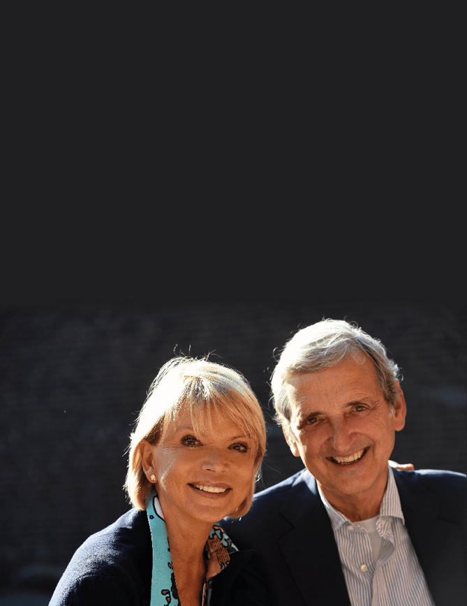 A man and woman are smiling for a picture. Description generated by AI