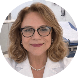 A woman wearing a white lab coat. Description generated by AI