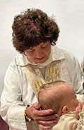 A woman holding a baby. Description generated by AI