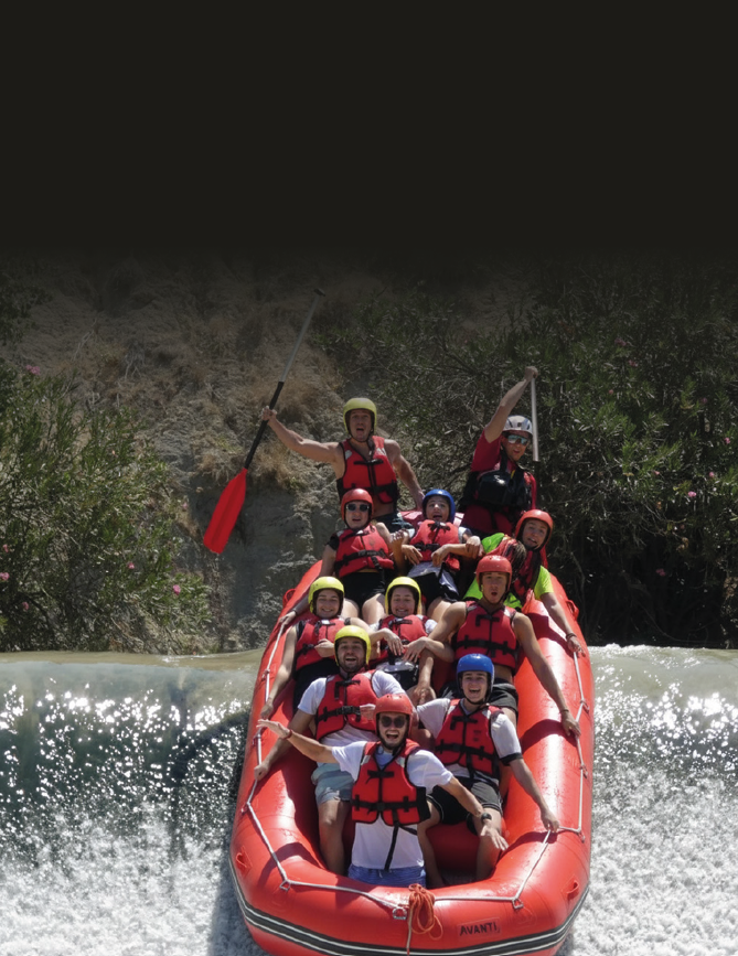 A group of people are on a raft in a river. Description generated by AI