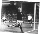 A soccer player in a black and white photo is about to kick the ball. Description generated by AI