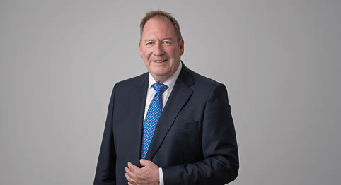 A man wearing a blue tie. Description generated by AI
