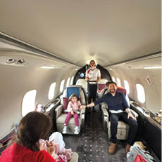 A group of people are sitting in a plane. Description generated by AI