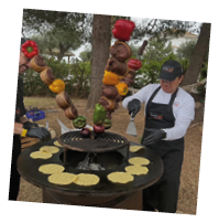 A man is cooking food on a grill. Description generated by AI