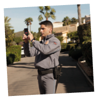 A man in a grey uniform is taking a picture. Description generated by AI