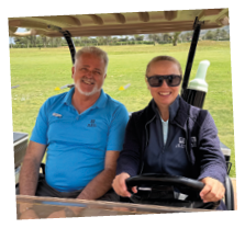 A man and a woman are sitting in a golf cart. Description generated by AI