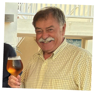 A man holding a glass of beer. Description generated by AI