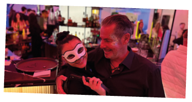 A man and woman are standing in a bar. Description generated by AI