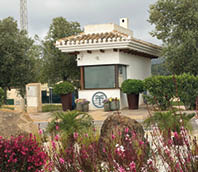 A white building with a brown roof. Description generated by AI