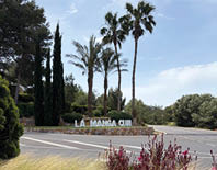 A sign in front of a building that says La Manga Club. Description generated by AI