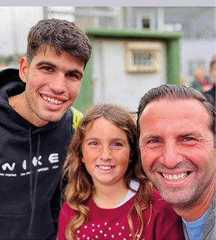 A man and a girl are smiling and posing for a picture. Description generated by AI