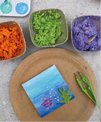 A plate with a card on it and a pair of green scissors. Description generated by AI
