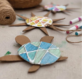 A wooden turtle decoration with a blue and green pattern. Description generated by AI