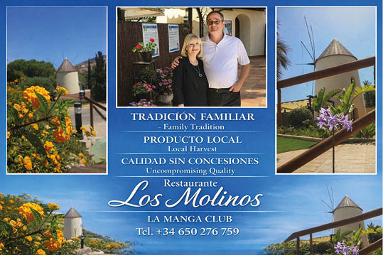 A man and a woman standing in front of a sign for Los Molinos. Description generated by AI