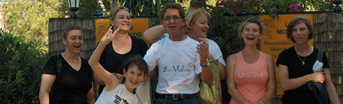 A group of people standing outside. Description generated by AI