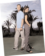 A man and woman pose together on a lush green field. AI generated content