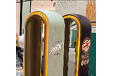 Two beer taps with a green and a brown label. Description generated by AI