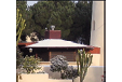 A house with a red roof and a white chimney. Description generated by AI