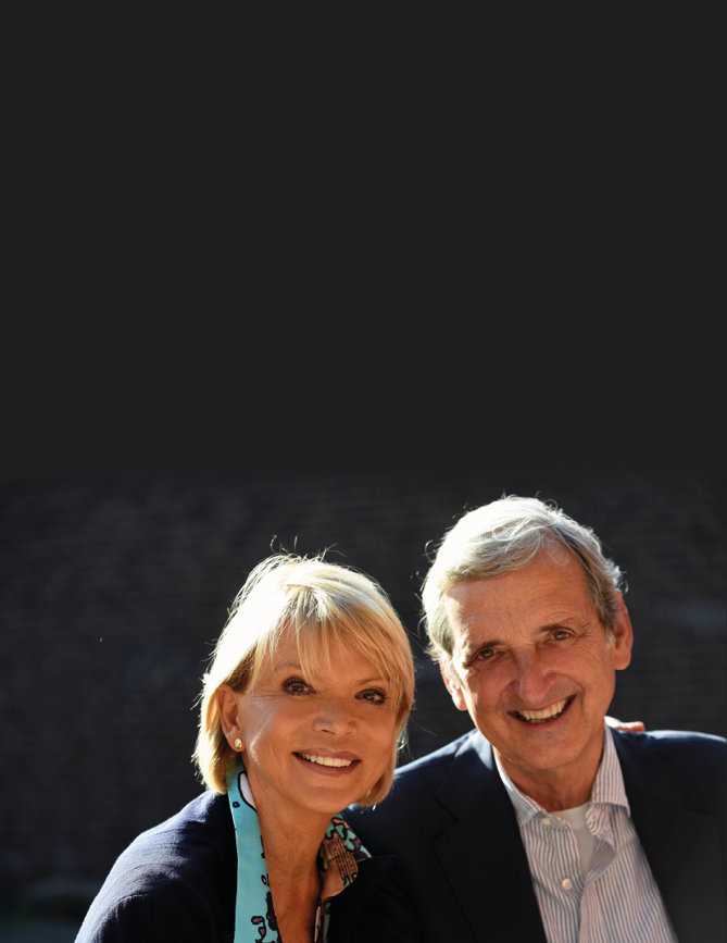 A man and woman are smiling for a picture. Description generated by AI