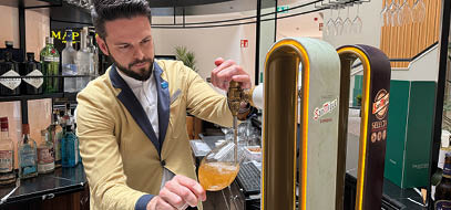 A man pouring a drink into a glass. Description generated by AI