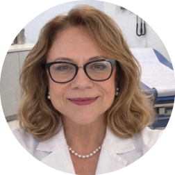 A woman wearing a white lab coat. Description generated by AI