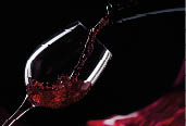 bottle and glass with red wine on a black background
